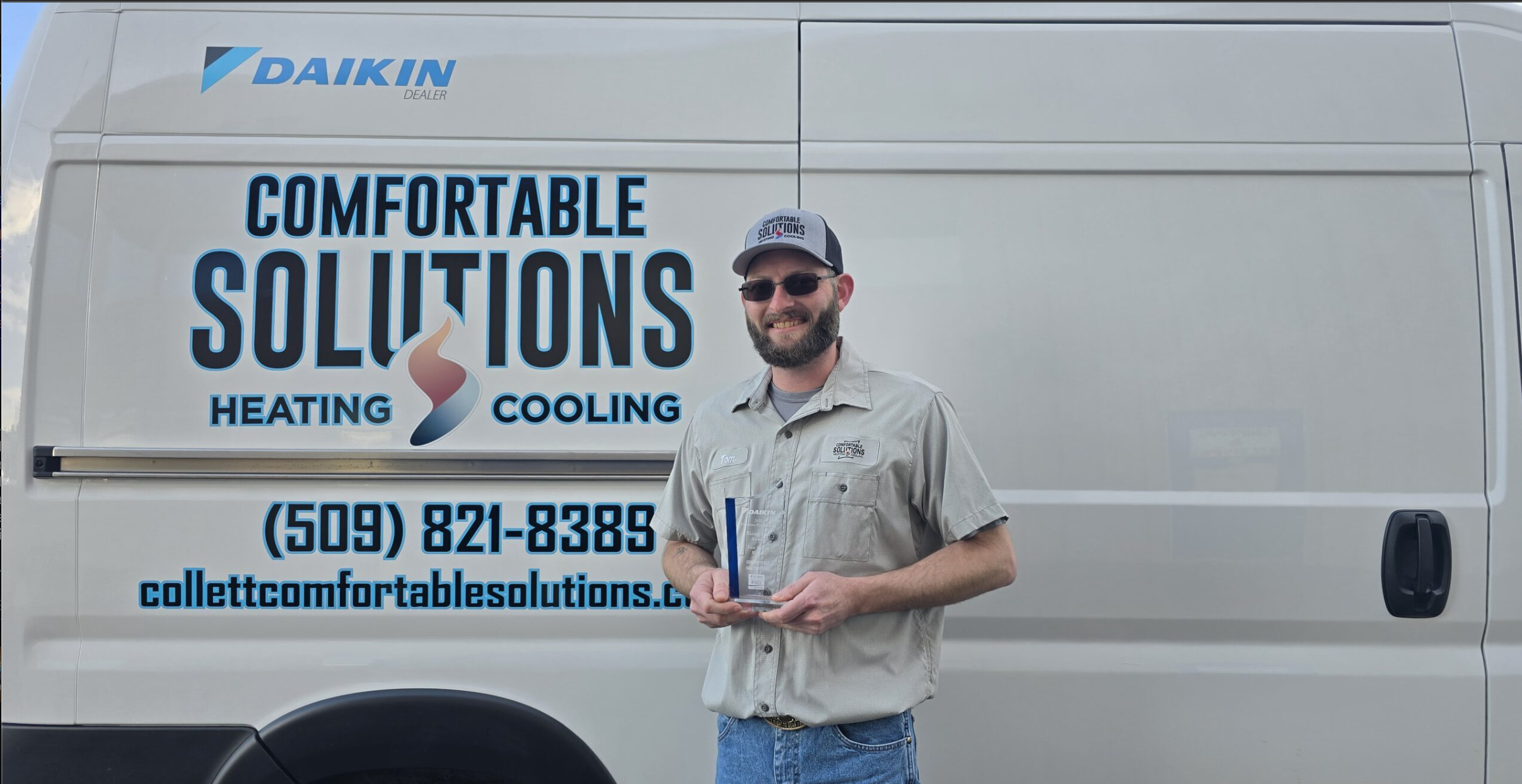 Collett Comfortable Solutions technician in front of the service van
